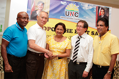 Prime Minister Kamla Persad-Bissessar greets former Clico chairman Gerard Yetming, second left, and former Senate president Timothy Hamel-Smith, second right, after they showed up at a UNC “foot soldiers” mobilisation meeting in Debe on Tuesday. Also in photo are Oropouche East MP Dr Roodal Moonilal and UNC campaign manager Rodney Charles, left. PHOTO: RISHI RAGOONATH